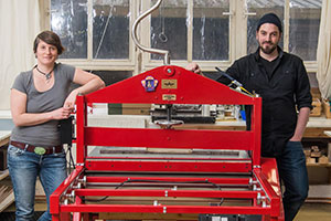 photo of Sarah and Ulrich printing etchings